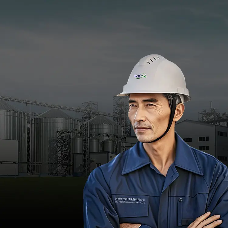 An engineer in a white helmet and a biomass pellet plant in the background.