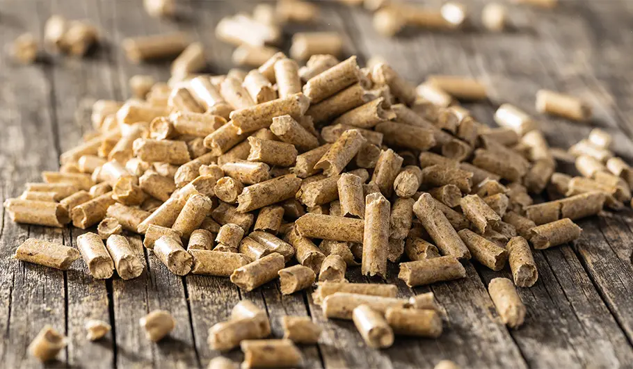 The dense wood pellets on a wooden table.
